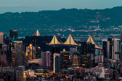 Illuminated cityscape against sky