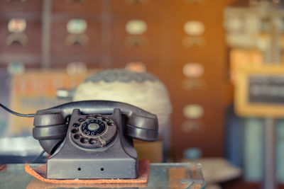 Close-up of old telephone on table