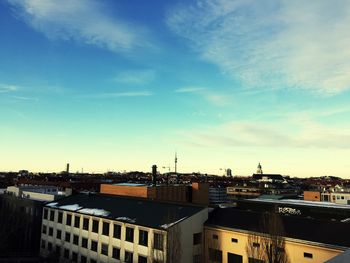 Cityscape against cloudy sky