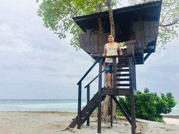 Lifeguard hut on beach against sky