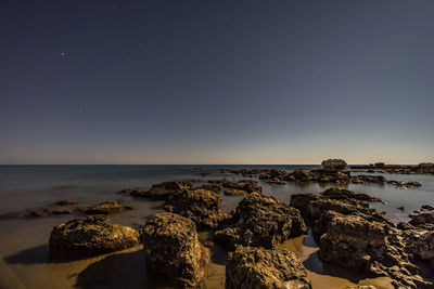 Scenic view of sea against sky at night