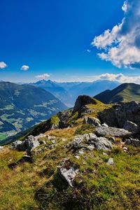 Scenic view of mountains against blue sky