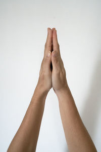 Close-up of person hand against white background