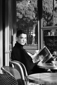 Portrait of a boy sitting on book