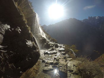 Scenic view of bright sun over mountains