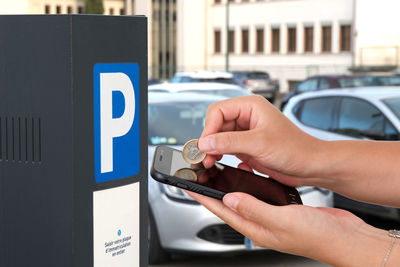 Close-up of hand holding smart phone in car