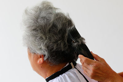 Close-up portrait of a woman over white background