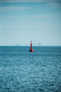 Sailboat on sea against sky