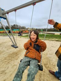 Boy swinging at playground