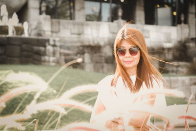 Portrait of woman wearing sunglasses outdoors