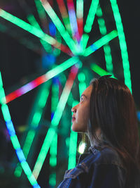 Portrait of a smiling young woman at night