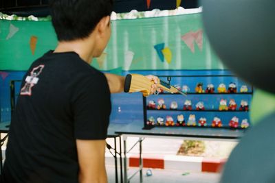 Rear view of man playing piano