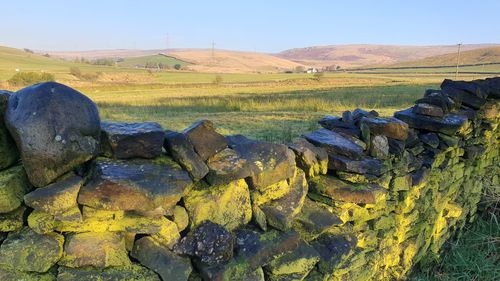 Scenic view of rocks on field against sky