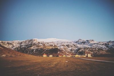 Scenic view of snowcapped mountains against clear blue sky