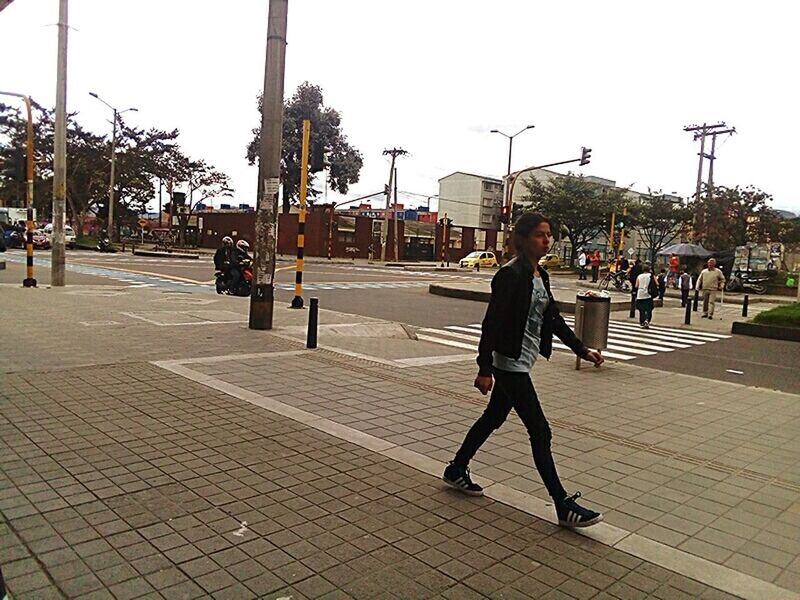 FULL LENGTH OF MAN WITH UMBRELLA IN CITY