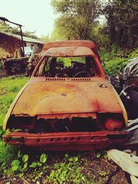 Abandoned car on field