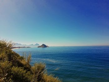 Scenic view of sea against clear blue sky