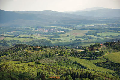 View of fields and hills at sunset in the tuscan countryside, italy.