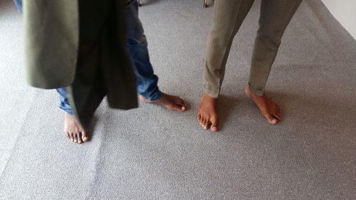 Low section of people standing on floor