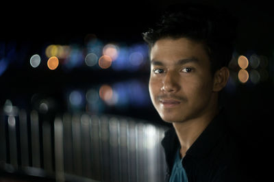 Portrait of young man at night