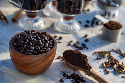 Still life with coffee beans, ground coffee, coffee gwooden spoon for making coffee at home