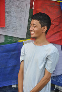 Young man standing against prayer flag