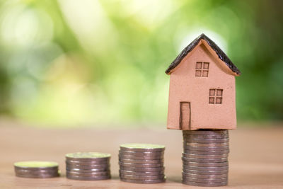 Close-up of coins in house against building