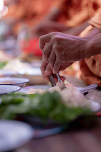 Midsection of person preparing food on table