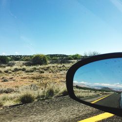 View of side-view mirror against clear sky