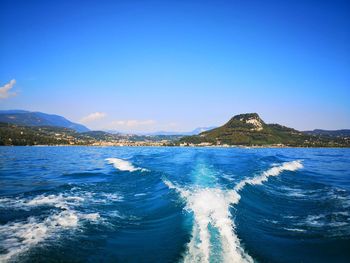 Scenic view of sea against clear blue sky