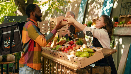 Rear view of man holding food at market