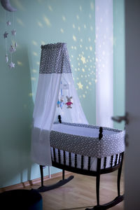 Baby crib against wall at home