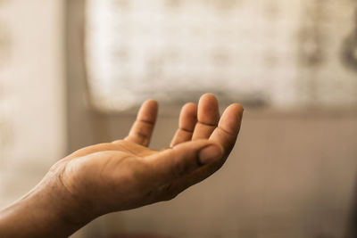 Cropped image of person hand holding invisible product