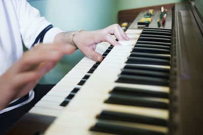 Midsection of man playing piano