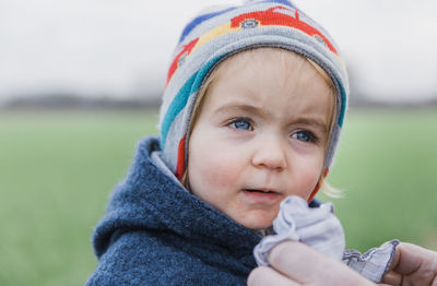 Close-up of cute girl in park during winter