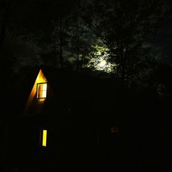 Low angle view of illuminated building against sky at night