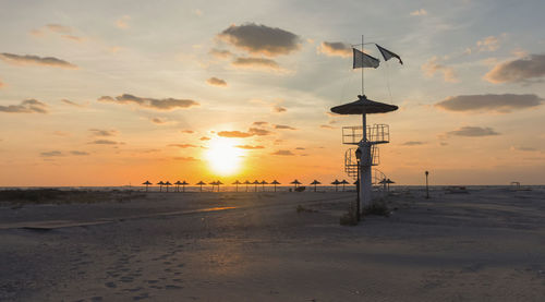 Scenic view of beach against sky during sunset