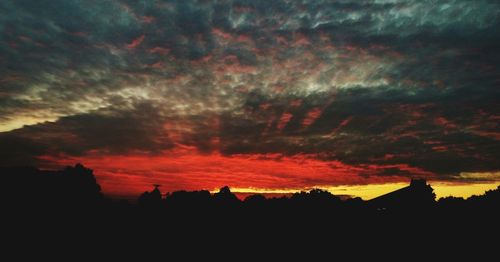 Silhouette of built structure at sunset