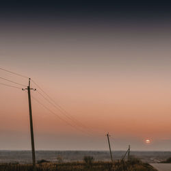 Electricity pylon on countryside landscape against the sky