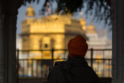 Rear view of man standing against temple