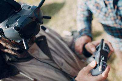 Midsection of man using mobile phone