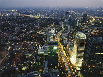 High angle view of city lit up at night