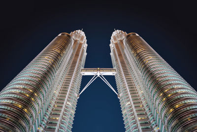 Low angle view of buildings against sky at night