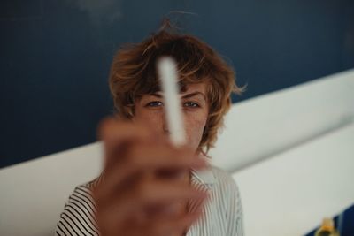 Portrait of woman holding chalk