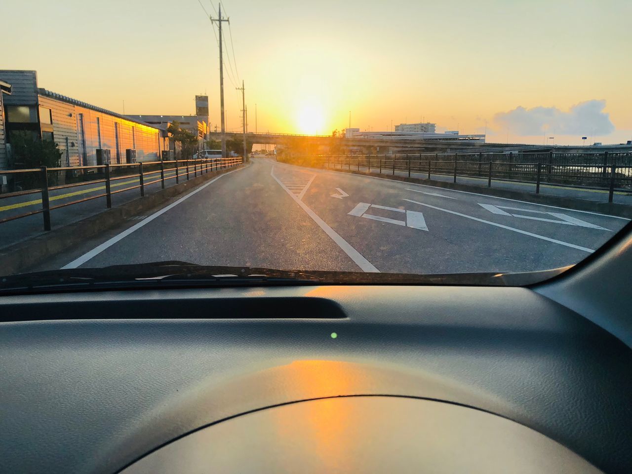 ROAD SEEN THROUGH CAR WINDSHIELD