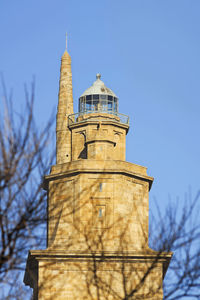 Low angle view of bell tower against blue sky