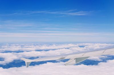 Airplane wing against blue sky