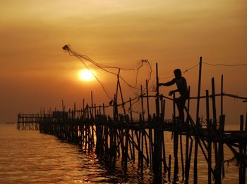 People fishing at sunset