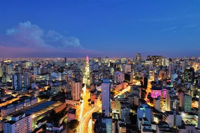 High angle view of illuminated buildings against sky in city