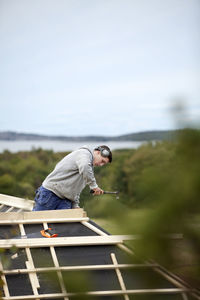 Man working on house roof